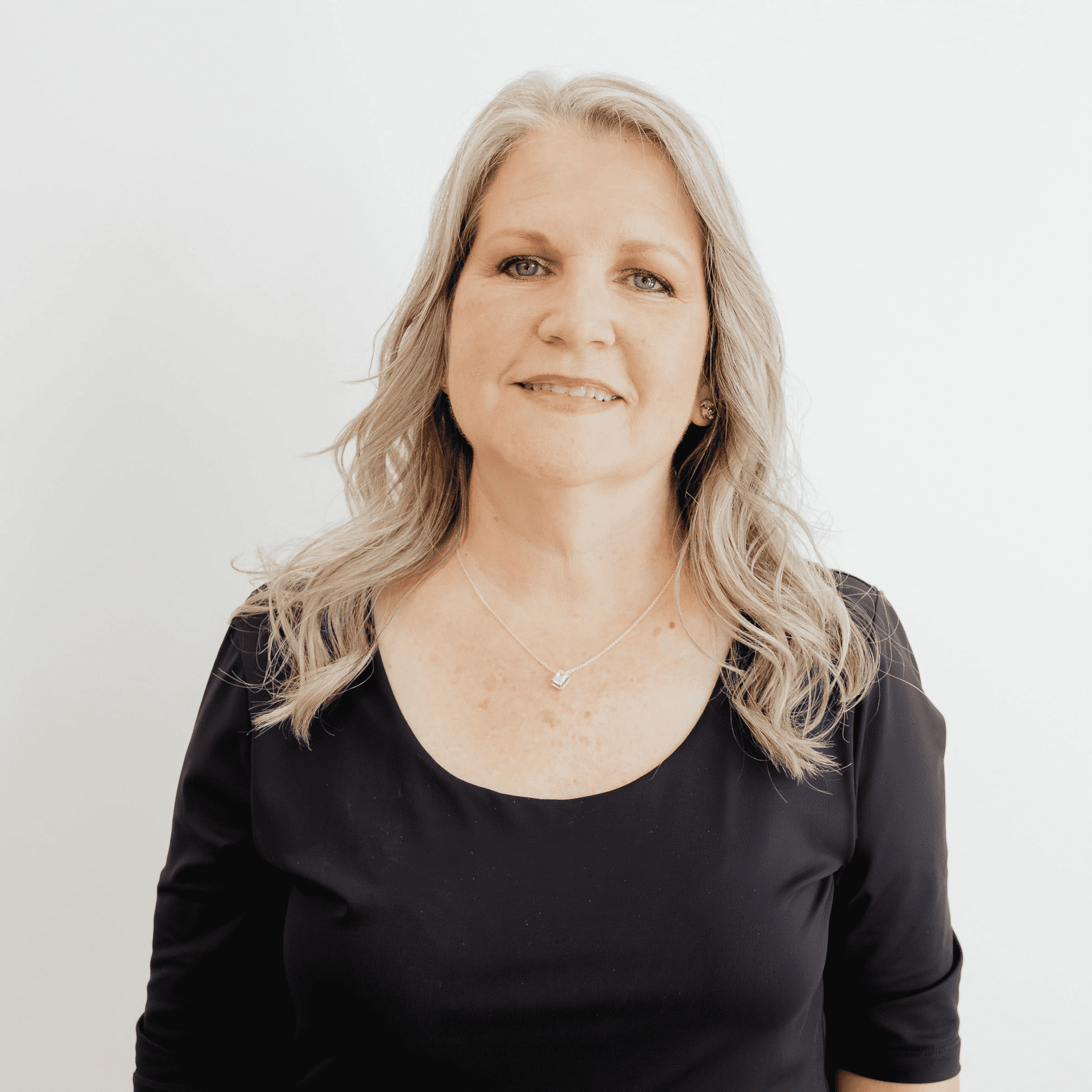 Portrait of Janet Miller, a professional stylist at Flying Scissors Salon & Spa, showcasing their expertise and style.