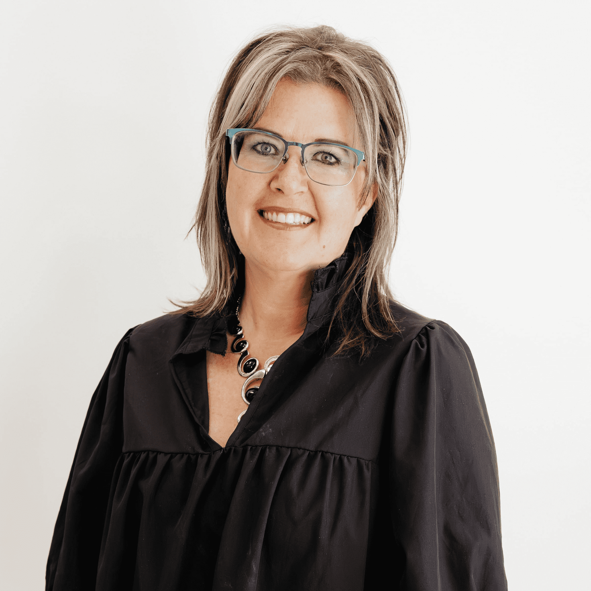 Portrait of Katie Chowela, a professional stylist at Flying Scissors Salon & Spa, showcasing their expertise and style.