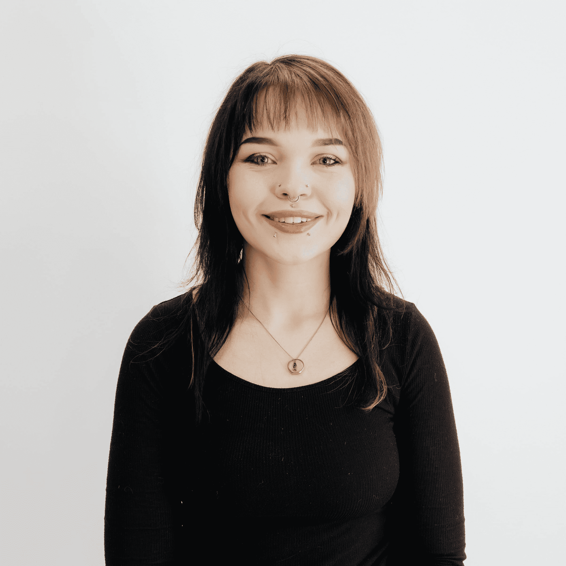 Portrait of Madison Rychter, a professional stylist at Flying Scissors Salon & Spa, showcasing their expertise and style.