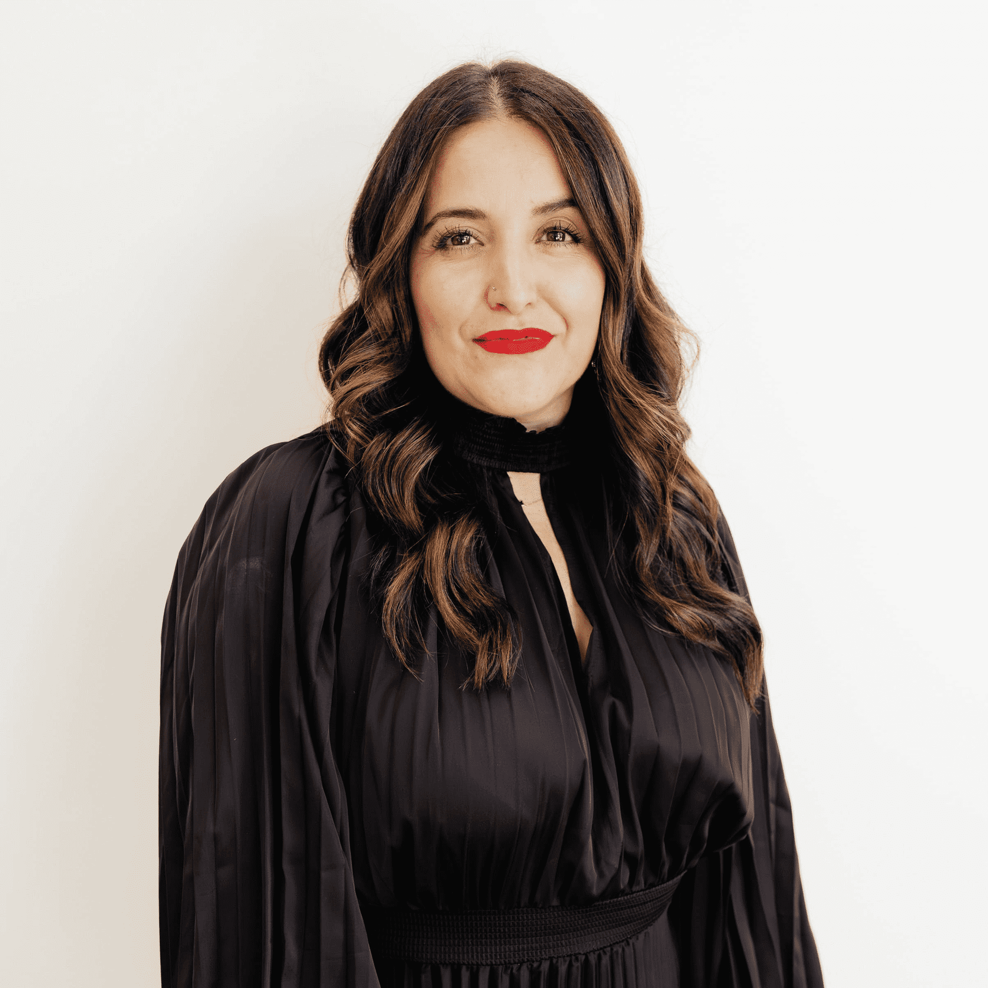 Portrait of Cris Andrade, a professional stylist at Flying Scissors Salon & Spa, showcasing their expertise and style.