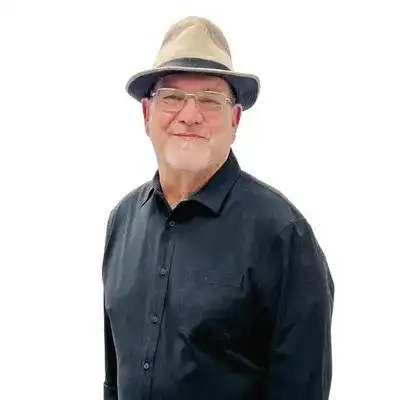 Portrait of Roger Martin, a professional stylist at Flying Scissors Salon & Spa, showcasing their expertise and style.