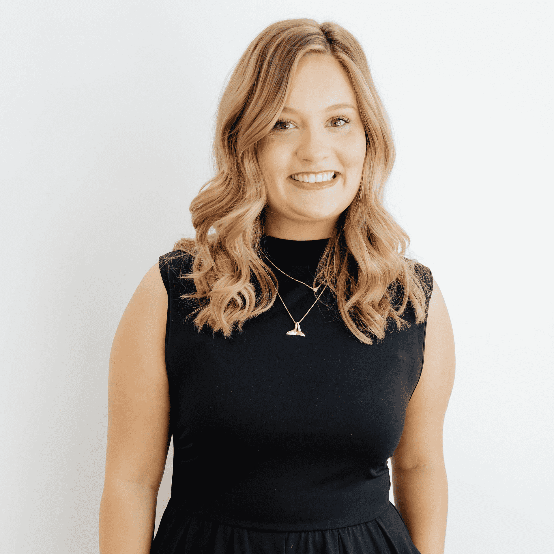Portrait of Taylor Whitehead, a professional stylist at Flying Scissors Salon & Spa, showcasing their expertise and style.
