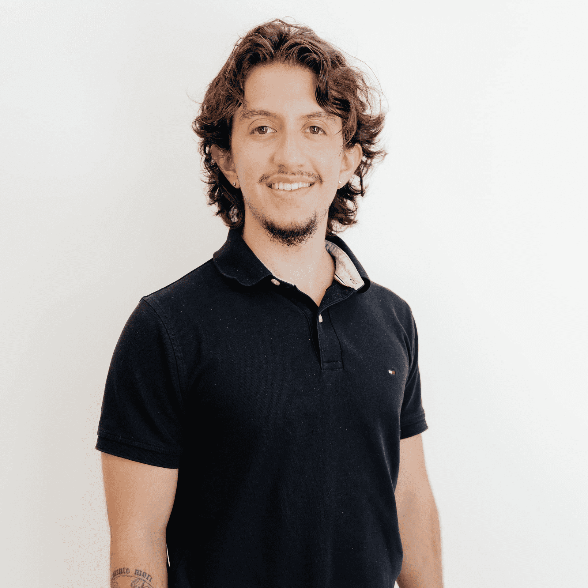 Portrait of Nicolas Andrade, a professional stylist at Flying Scissors Salon & Spa, showcasing their expertise and style.