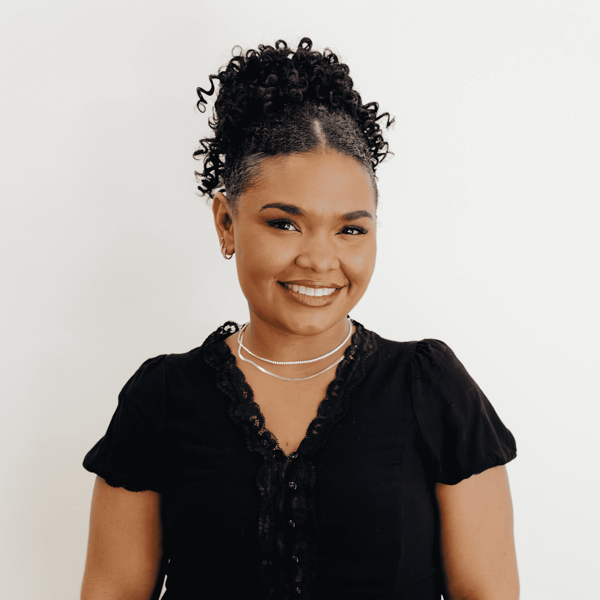 Portrait of Maholy Marte, a professional stylist at Flying Scissors Salon & Spa, showcasing their expertise and style.