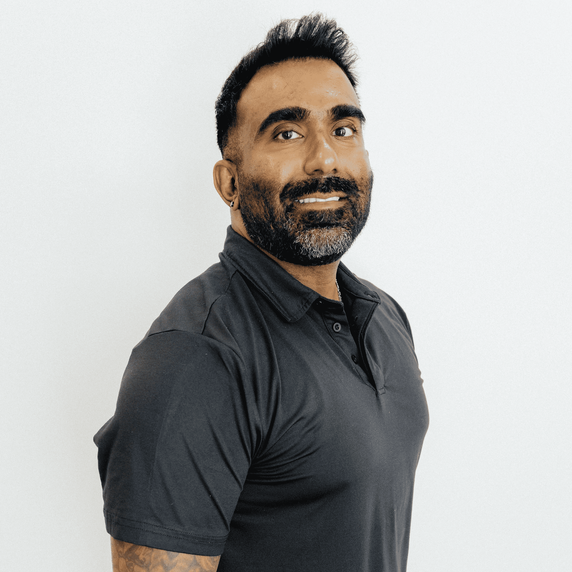 Portrait of Deo Rampersaud, a professional stylist at Flying Scissors Salon & Spa, showcasing their expertise and style.